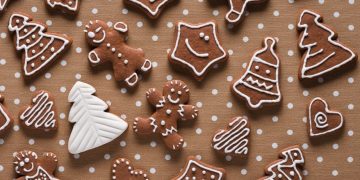 Homemade gingerbread on beige dots background top view by Kamil Zabłocki